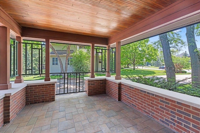 5870 Persimmon Dr, Fitchburg, WI 53711 - unfurnished sunroom with stone finish flooring, wood ceiling, and plenty of natural light