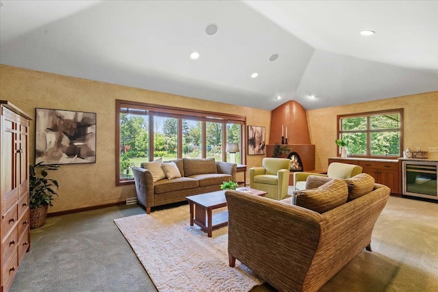 5870 Persimmon Dr, Fitchburg, WI 53711 - living area with light colored carpet, vaulted ceiling, healthy amount of natural light, recessed lighting, and beverage cooler