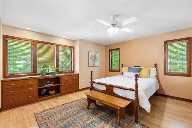 5870 Persimmon Dr, Fitchburg, WI 53711 - bedroom featuring multiple windows, light wood-style floors, a ceiling fan, and recessed lighting