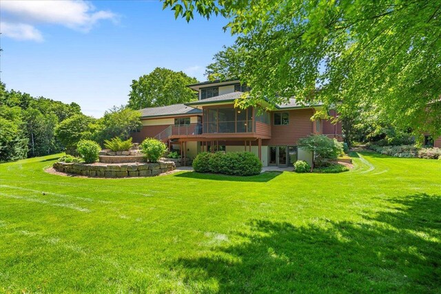 5870 Persimmon Dr, Fitchburg, WI 53711 - back of house featuring a sunroom, a lawn, and french doors