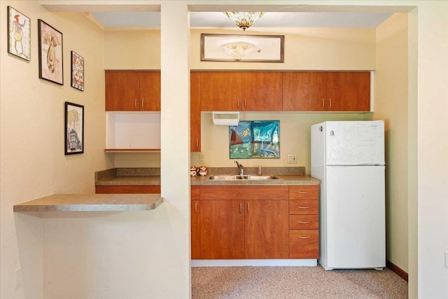 5870 Persimmon Dr, Fitchburg, WI 53711 - kitchen featuring freestanding refrigerator, brown cabinets, and light carpet