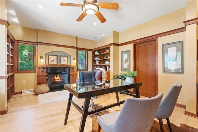 5870 Persimmon Dr, Fitchburg, WI 53711 - office area featuring a lit fireplace, built in features, light wood-style floors, a ceiling fan, and recessed lighting