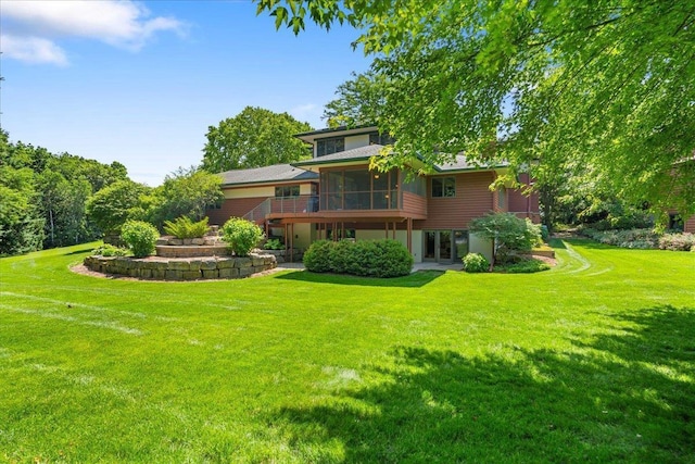 5870 Persimmon Dr, Fitchburg, WI 53711 - back of house featuring a sunroom, a lawn, and french doors