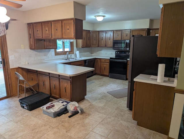3664 Martin Rd, Kronenwetter, WI 54455 - kitchen featuring black appliances, a peninsula, decorative backsplash, light countertops, and ceiling fan