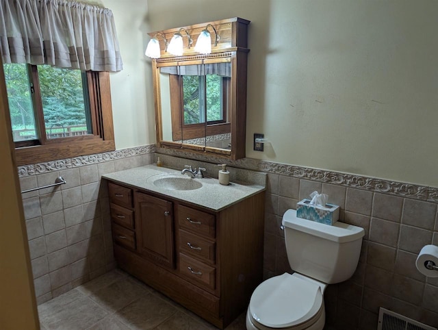 3664 Martin Rd, Kronenwetter, WI 54455 - half bath with tile walls, vanity, wainscoting, and tile patterned floors