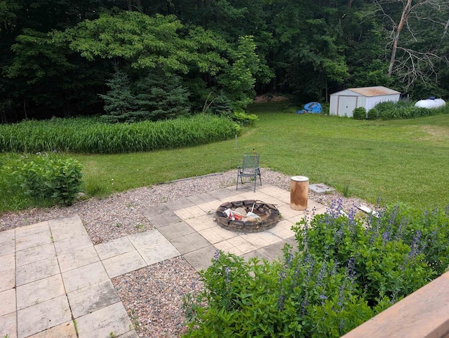 3664 Martin Rd, Kronenwetter, WI 54455 - view of patio with a storage shed, an outdoor fire pit, and a forest view
