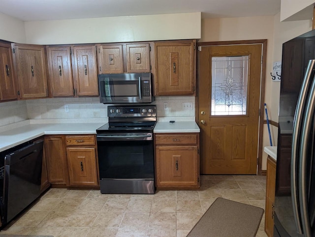 3664 Martin Rd, Kronenwetter, WI 54455 - kitchen with black appliances, light countertops, backsplash, and brown cabinets
