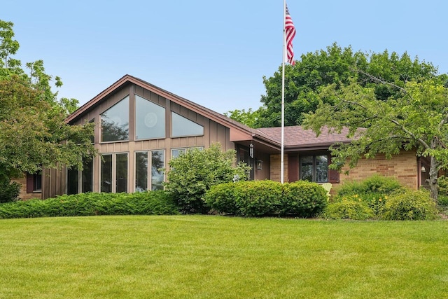 S46W22428 Tansdale Rd, Waukesha, WI 53189 - back of property with a yard, brick siding, and board and batten siding