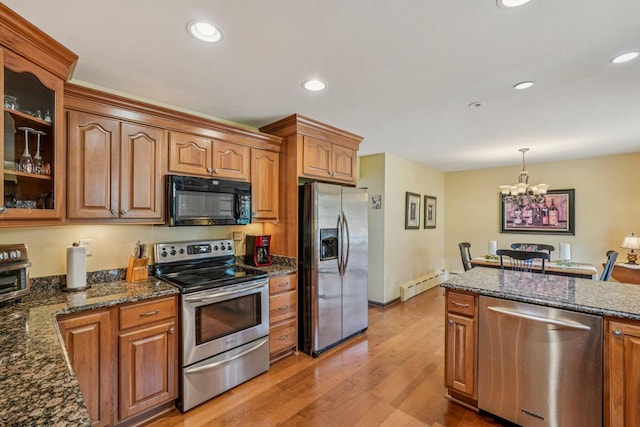 S46W22428 Tansdale Rd, Waukesha, WI 53189 - kitchen featuring appliances with stainless steel finishes, baseboard heating, glass insert cabinets, a chandelier, and brown cabinetry