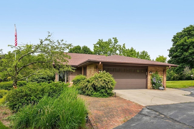 S46W22428 Tansdale Rd, Waukesha, WI 53189 - view of front of house with driveway, an attached garage, and brick siding
