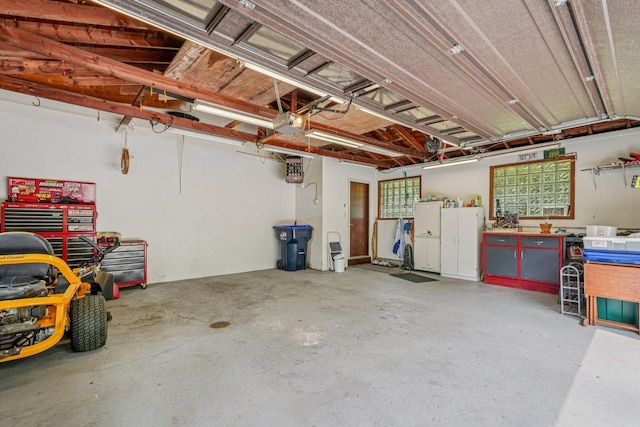 S46W22428 Tansdale Rd, Waukesha, WI 53189 - garage with a workshop area, a garage door opener, and refrigerator