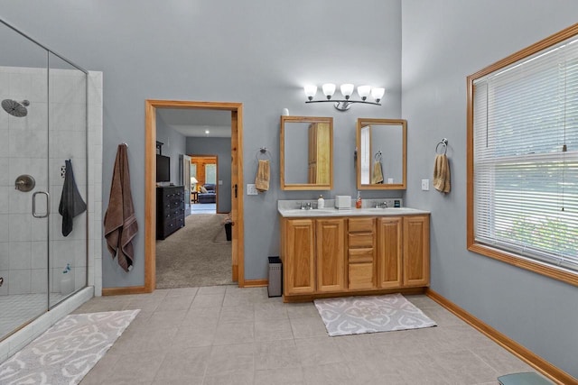 1201 Lance Dr, Twin Lakes, WI 53181 - ensuite bathroom with a stall shower, double vanity, tile patterned flooring, and a chandelier