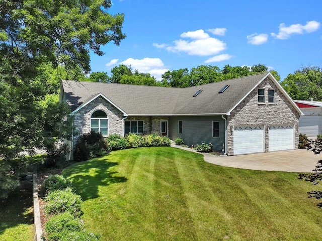1201 Lance Dr, Twin Lakes, WI 53181 - view of front of property featuring stone siding, concrete driveway, a front yard, a garage, and roof with shingles