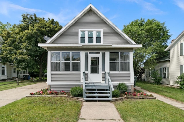 215 W Burns St, Portage, WI 53901 - bungalow-style home featuring a sunroom and a front yard