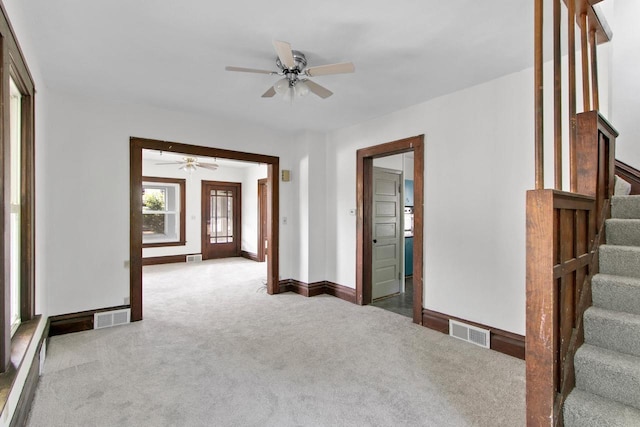 215 W Burns St, Portage, WI 53901 - carpeted empty room featuring ceiling fan and stairway