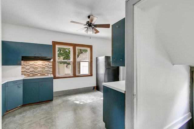 215 W Burns St, Portage, WI 53901 - kitchen featuring under cabinet range hood, ceiling fan, black appliances, decorative backsplash, and blue cabinets