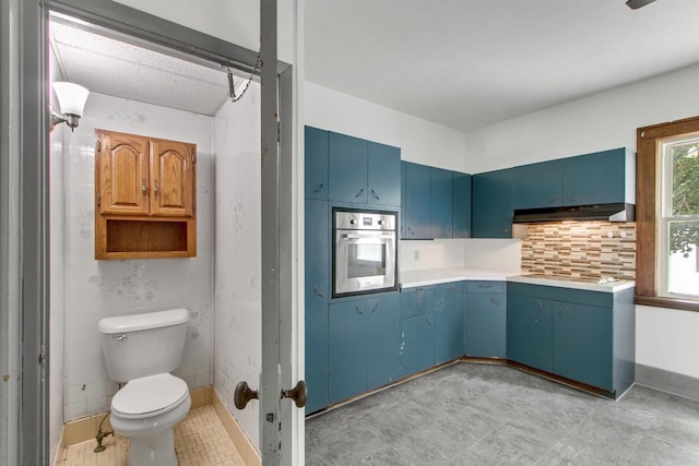 215 W Burns St, Portage, WI 53901 - bathroom featuring toilet and decorative backsplash