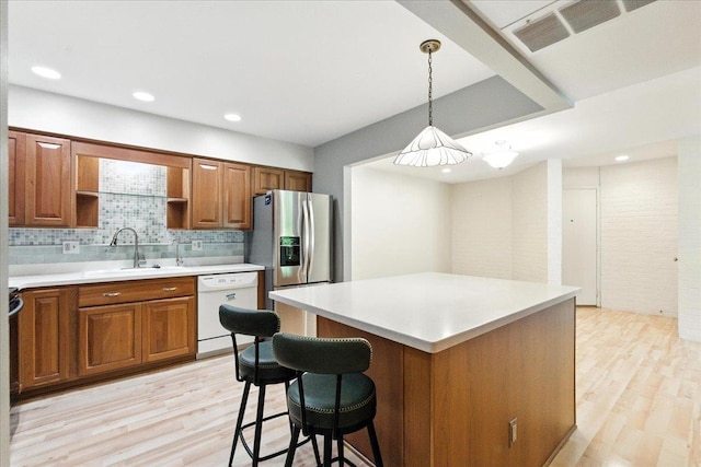 3107 Harbor Village Rd Unit 1, Middleton, WI 53562 - kitchen featuring white dishwasher, light wood-type flooring, brown cabinets, open shelves, and tasteful backsplash