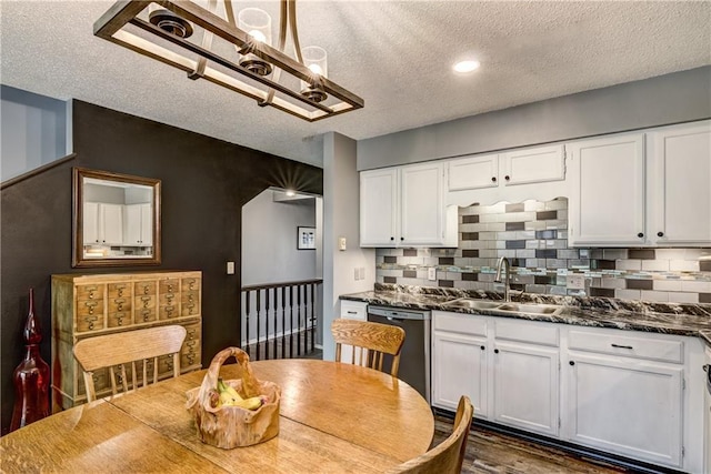 45 Stump Lake Rd Unit 6, Chippewa Falls, WI 54729 - kitchen featuring dishwashing machine, a textured ceiling, white cabinets, a chandelier, and backsplash