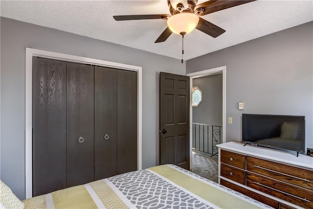 45 Stump Lake Rd Unit 6, Chippewa Falls, WI 54729 - bedroom with a closet, a textured ceiling, and a ceiling fan