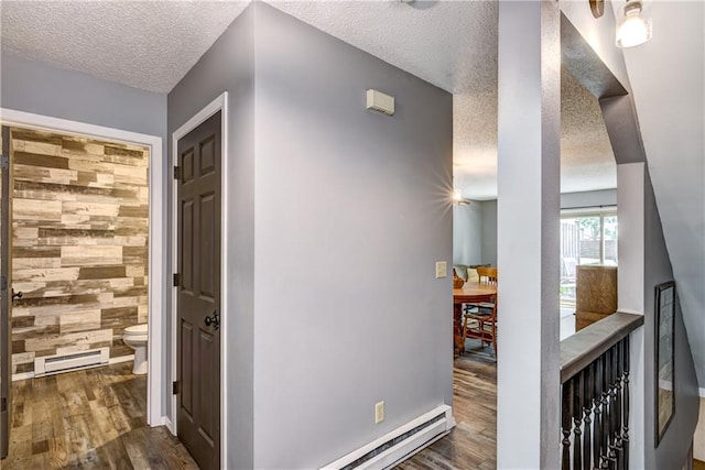 45 Stump Lake Rd Unit 6, Chippewa Falls, WI 54729 - hall featuring a textured ceiling, wood finished floors, and a baseboard heating unit