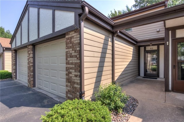 45 Stump Lake Rd Unit 6, Chippewa Falls, WI 54729 - view of home's exterior with brick siding and driveway