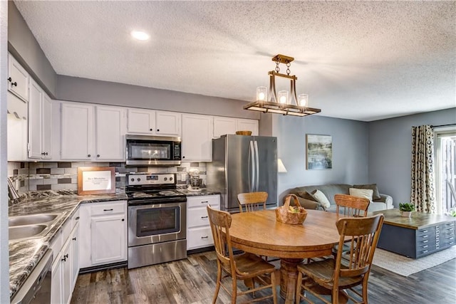 45 Stump Lake Rd Unit 6, Chippewa Falls, WI 54729 - kitchen featuring appliances with stainless steel finishes, dark wood-style floors, white cabinetry, a textured ceiling, and recessed lighting
