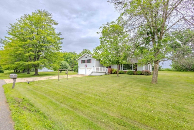 7040 Blonien Ave, Rudolph, WI 54475 - view of green lawn with a garage and concrete driveway