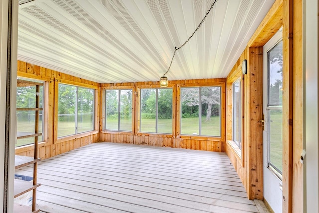 7040 Blonien Ave, Rudolph, WI 54475 - unfurnished sunroom featuring healthy amount of natural light, wooden walls, and hardwood / wood-style floors