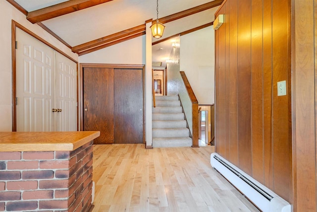 7040 Blonien Ave, Rudolph, WI 54475 - entryway with a baseboard radiator, wood finished floors, wood walls, and stairs