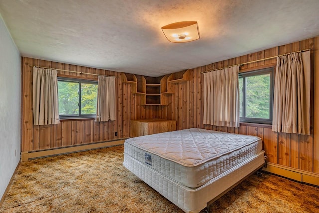7040 Blonien Ave, Rudolph, WI 54475 - bedroom featuring a baseboard heating unit, multiple windows, wood walls, and carpet floors