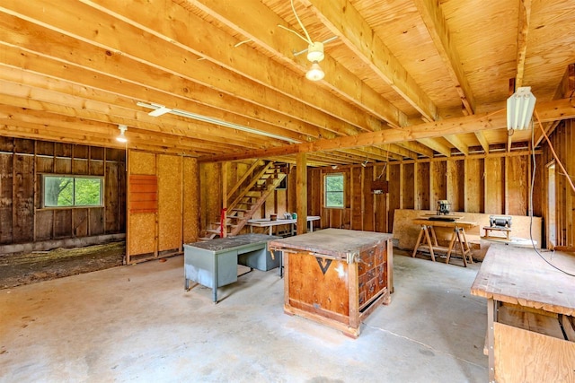 7040 Blonien Ave, Rudolph, WI 54475 - miscellaneous room with healthy amount of natural light, concrete flooring, and stairway