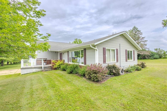 7040 Blonien Ave, Rudolph, WI 54475 - view of front of home with a front lawn and a wooden deck