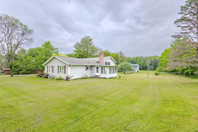 7040 Blonien Ave, Rudolph, WI 54475 - rear view of property featuring a chimney, a yard, and a sunroom