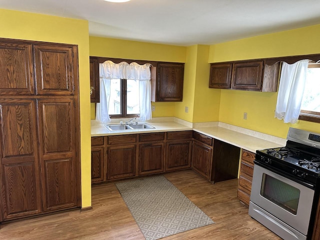 2467 N Bartlett Ave Unit 2467A, Milwaukee, WI 53211 - kitchen featuring stainless steel gas range, light wood-style flooring, and healthy amount of natural light