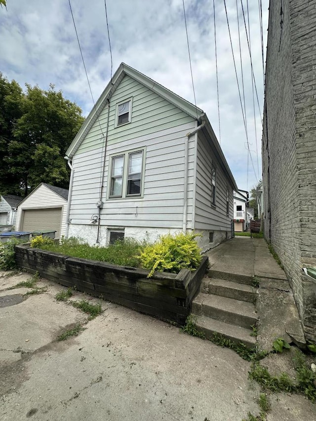 2467 N Bartlett Ave Unit 2467A, Milwaukee, WI 53211 - view of side of home featuring a detached garage and an outbuilding