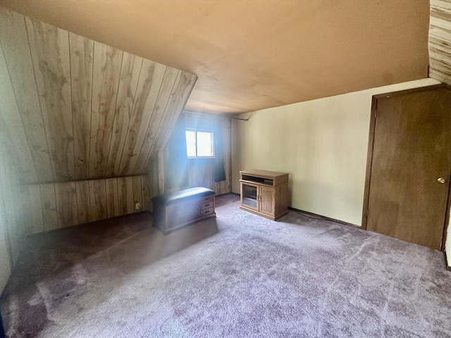 2467 N Bartlett Ave Unit 2467A, Milwaukee, WI 53211 - bonus room with a wood stove, carpet flooring, vaulted ceiling, and wood walls
