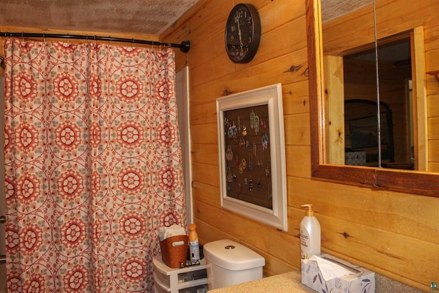 68165 Front St, Iron River, WI 54847 - full bathroom featuring wood walls, a shower with curtain, and vanity