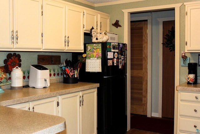 68165 Front St, Iron River, WI 54847 - kitchen with freestanding refrigerator, light countertops, and white cabinetry
