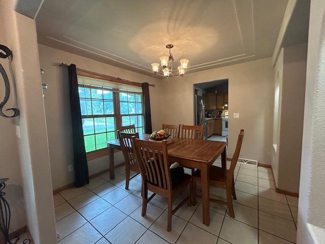 5201 Lombardy Dr, Wausau, WI 54401 - dining room with a chandelier and light tile patterned floors