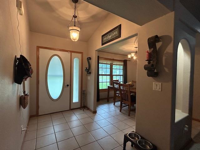 5201 Lombardy Dr, Wausau, WI 54401 - foyer with vaulted ceiling, a chandelier, light tile patterned floors, and arched walkways