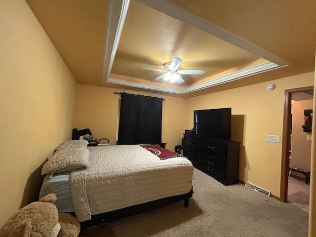 5201 Lombardy Dr, Wausau, WI 54401 - carpeted bedroom with a tray ceiling and ceiling fan