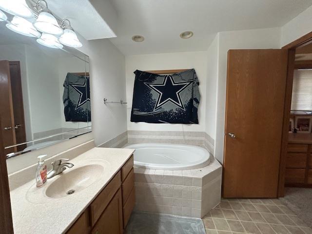 5201 Lombardy Dr, Wausau, WI 54401 - full bath with vanity, a garden tub, and tile patterned flooring