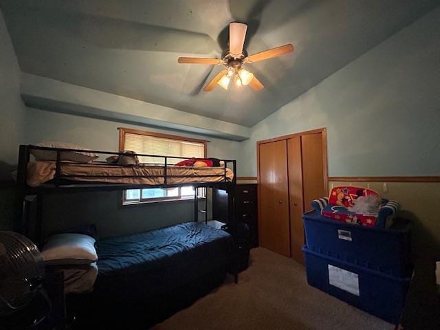 5201 Lombardy Dr, Wausau, WI 54401 - carpeted bedroom with a closet, lofted ceiling, a wainscoted wall, and a ceiling fan