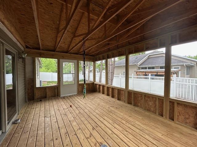 5201 Lombardy Dr, Wausau, WI 54401 - unfurnished sunroom featuring plenty of natural light, hardwood / wood-style flooring, a wooden deck, and lofted ceiling