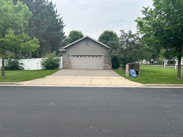 5201 Lombardy Dr, Wausau, WI 54401 - view of front of home featuring a garage and stone siding