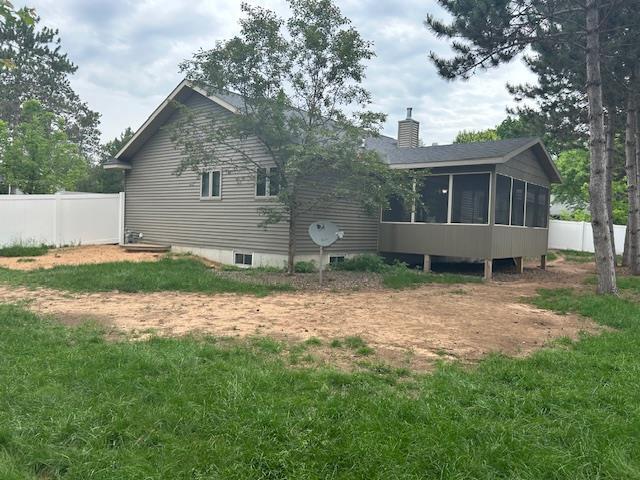 5201 Lombardy Dr, Wausau, WI 54401 - back of house featuring a chimney and a sunroom