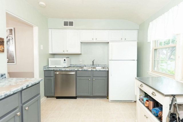 6533 W Center St, Wauwatosa, WI 53210 - kitchen with white appliances, gray cabinetry, white cabinets, and light stone counters