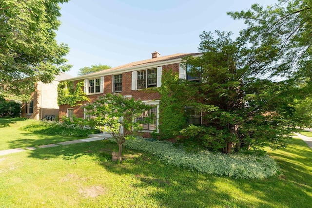 6533 W Center St, Wauwatosa, WI 53210 - view of front of property with brick siding, a chimney, and a front lawn