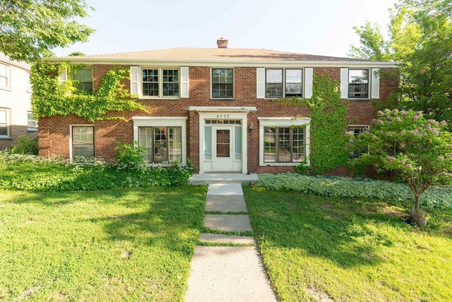 6533 W Center St, Wauwatosa, WI 53210 - view of front of house with a front lawn, a chimney, and brick siding
